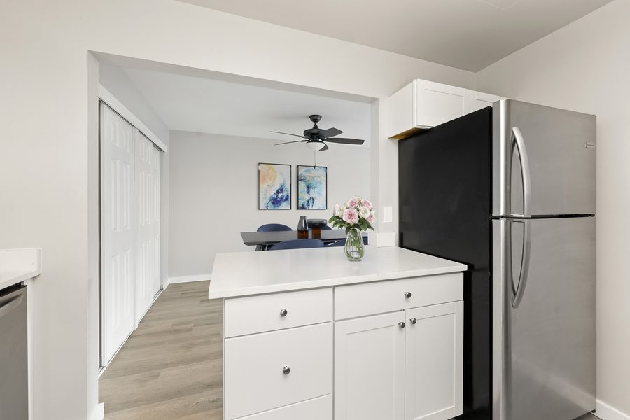 Kitchen with stainless refrigerator